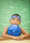 Little Boy Playing In Swimming Pool Stock Photo