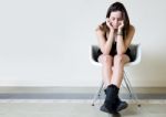 Depressed Young Woman Sitting At Home Stock Photo