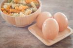 Fresh Eggs On Wooden Plate With Fusili Stock Photo