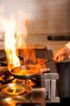 Chef Cooking In Kitchen Stove Stock Photo