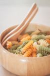 Raw Fusilli Pasta In Wooden Bowl Stock Photo