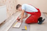 Man Laying Laminate Flooring Stock Photo