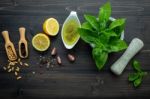 The Ingredients For Green Pesto Sauce On Dark Wooden Background Stock Photo