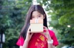 Portrait Of Thai Teen Beautiful Girl In Chinese Dress, Happy New Year And Open Box Gift, Smile And Very Happy Stock Photo