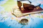 Compass, Passport, Money And Sunglasses On The Map Stock Photo