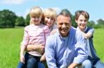 Joyful Family Of Four On A Bright Sunny Day Stock Photo