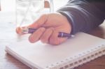 Woman Hand With Pen Writing On Notebook Stock Photo