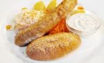 Sausages With Vegetables On A Plate Closeup Stock Photo