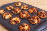 Muffins With Chocolate Chips In Baking Tray Stock Photo