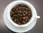 Cup Filled With Coffee Beans Stock Photo