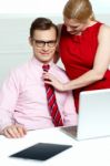 Female Adjusting Her Co Workers Tie Stock Photo