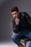 Casual Young Man In Black Leather Jacket And Denim Jeans Stock Photo