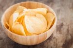 Crispy Potato Chips On Wooden Background Stock Photo