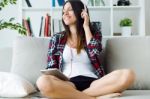 Beautiful Young Woman Listening To Music At Home Stock Photo