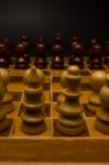 Light And Dark Wooden Chess Pieces On Chess Table Stock Photo