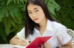 Thai Adult Student University Beautiful Girl Reading Red Book Stock Photo