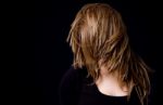 Portrait Of Woman Hiding Her Face With Hair Stock Photo