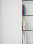 White Traditional Style Wood Cabinet With Book And Glass Shelf Stock Photo