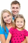 Parents Posing With Cute Smiling Daughter Stock Photo