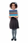 Active School Child Carrying Stack Of Books Stock Photo