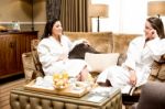 Relaxed Women Having Gossip At Breakfast Stock Photo