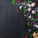 Top View Of Food Ingredients And Condiment On The Table, Ingredients And Seasoning On Dark Wooden Floor Stock Photo