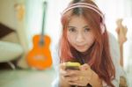 Young Asian Woman Listening To Music Stock Photo