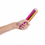 Colored Pencils In A Female Hand On A White Background  Stock Photo