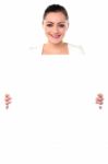 Smiling Woman Holding Blank White Ad Board Stock Photo