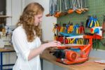 Dutch Teenage Girl Operating Electric Jigsaw In Classroom Stock Photo