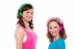 Teenage Sisters Listening To Music Stock Photo