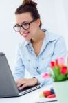 Woman With Laptop Working At Home Stock Photo