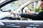 Young Man Driving A Nice Car, Using Gps Device Stock Photo