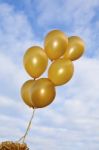 Flying Golden Balloons Stock Photo