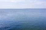 Blue Water Surface And Blue Sky Stock Photo