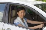 Smiling Woman Sitting In Car Stock Photo