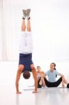 Asian Woman Looking Man Doing Handstand Exercise Stock Photo