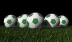 Green Soccer Balls On A Green Grass Stock Photo