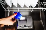 Washer Powder Pouring Into A Modern Dishwasher Stock Photo