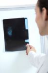 Attractive Young Female Doctor Examining X-ray Results Stock Photo