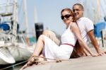 Couple Seated On Footbridge Stock Photo