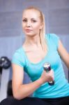 Attractive Blond 
 Sporty Girl Doing Biceps Training With Stock Photo