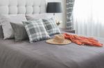 Classic Bed With Pillows, Hat, Cloth And Black Lamp Stock Photo