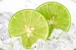 Cut Lime (citrus Aurantifolia (christm.)  Swingle) And Ice On Wh Stock Photo