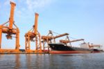 Big Container Ship On Port With Big Pier Lifting Crane  Use For Stock Photo