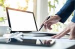 Business Man Working At Office With Laptop, Tablet And Graph Dat Stock Photo