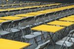 Rows Of Yellow Metal Tables And Chairs Stock Photo