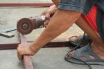 A Man Working With Grinder, Close Up On Tool Stock Photo