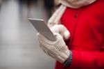 Woman In Wool Gloves Hold Smart-phone Stock Photo