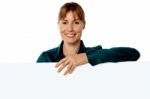 Cheerful Woman Holding Blank Ad Board Stock Photo